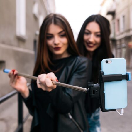 Two girls taking a photo with their ease to use selfie stick
