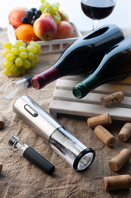 Electric wine opener with bootles of wines on the table