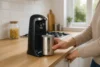 Modern automatic can opener in action on a kitchen counter